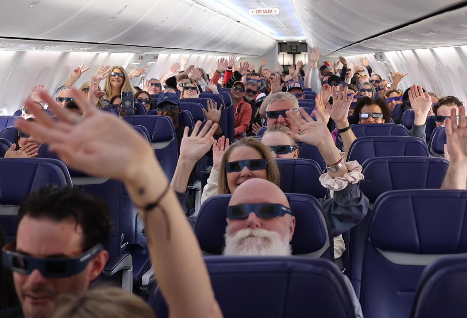 Passengers and crew take a photo wearing solar eclipse glasses aboard Southwest flight 1252 from Dallas, Texas to Pittsburgh, Pennsylvania. / Credit: Justin Sullivan/Getty Images