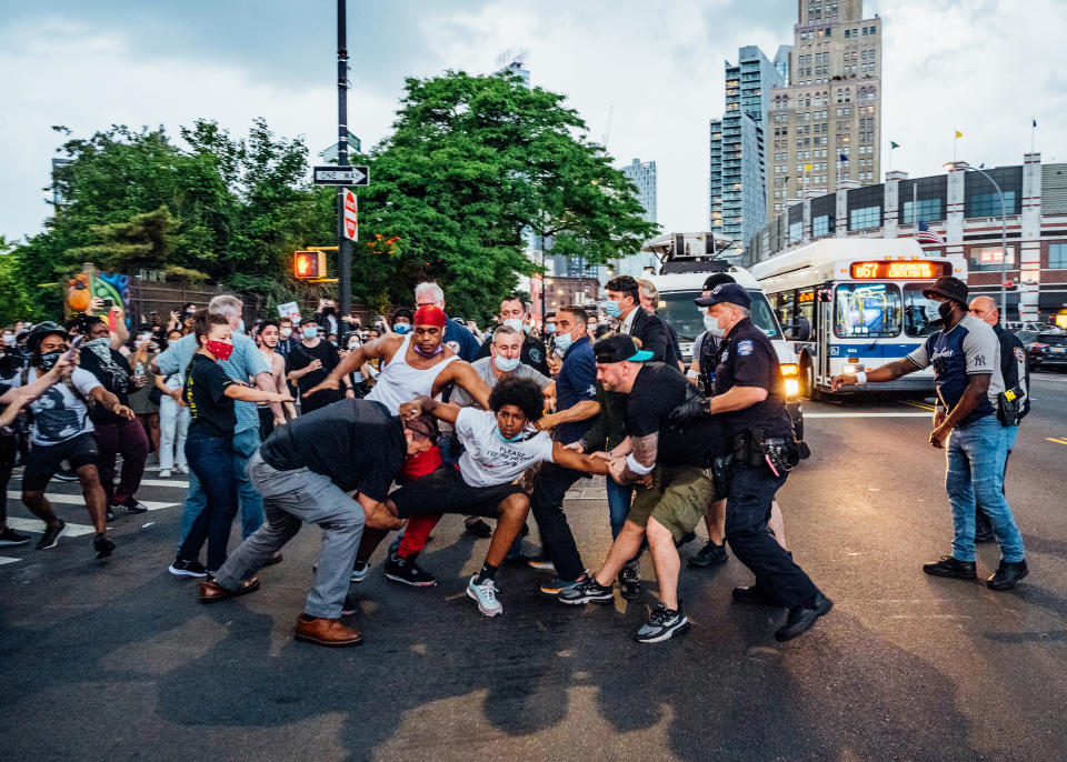A protester, wearing a shirt that reads "Please Stop the Violence," is dragged near Brooklyn's Barclays Center on May 29, <a href="https://time.com/5845369/george-floyd-protests-malike-sidibe/" rel="nofollow noopener" target="_blank" data-ylk="slk:four days" class="link ">four days</a> after George Floyd's death.<span class="copyright">Malike Sidibe for TIME</span>
