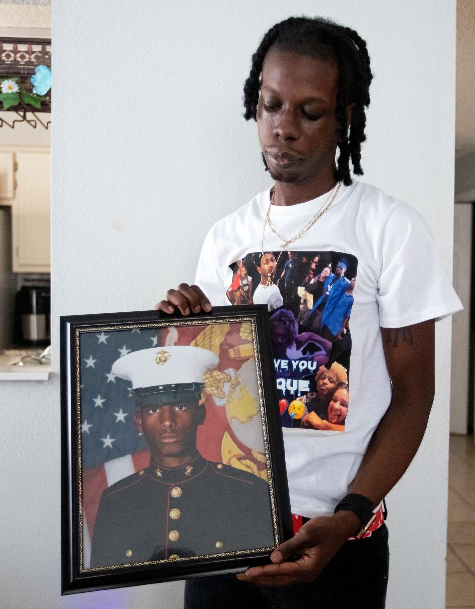 Jalen Richardson holds a photo on Tuesday, July 12, 2022 of his cousin Malique Richardson, a 24-year-old former Marine who was killed last week in Tallahassee, Fla. 