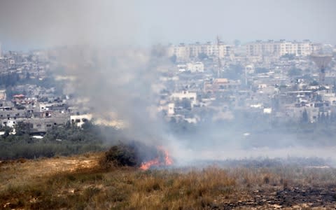 A fire burns in scrubland in Israel near the Gaza Strip, in an area where Palestinians have been causing blazes by flying kites and balloons loaded with flammable material - Credit: AMIR COHEN/REUTERS