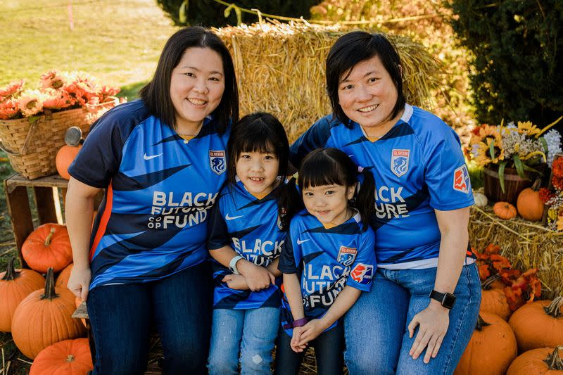 Same-sex parents Olivia and Irene pose with daughters Zoey and Vicky at Swans Trail Farm in Washington