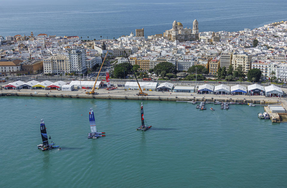 The New Zealand SailGP Team F50 catamaran, France SailGP Team F50 catamaran and Switzerland SailGP Team F50 catamaran are moored at the Technical Base base after being craned onto the water ahead of racing on Race Day 2 of the Spain Sail Grand Prix in Cadiz, Andalusia, Spain, Sunday, Sept. 25, 2022. (David Gray/SailGP via AP)