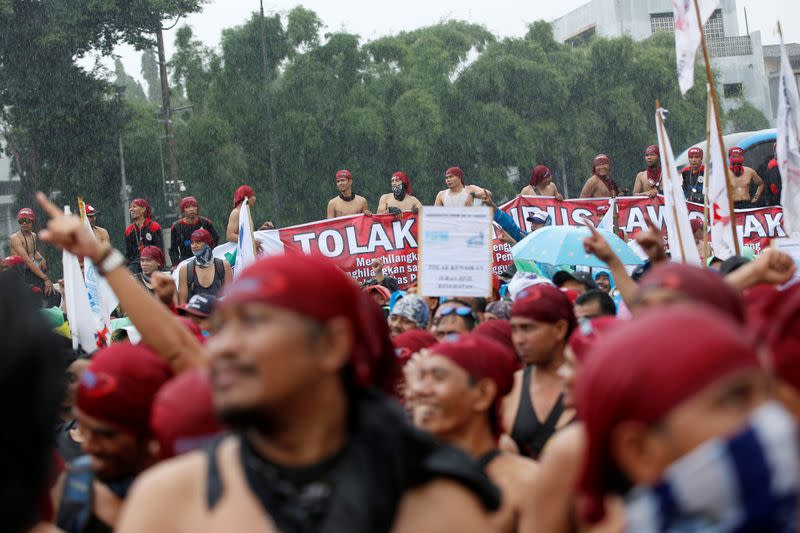 Labourers gather outside Indonesia's parliament building as they take part during a protest against government plans to change restrictive labour regulations through so-called "Omnibus Laws" in Jakarta