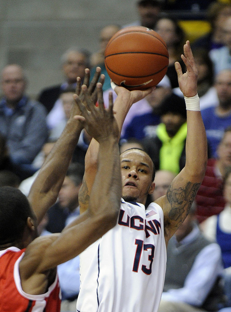 FILE - In this March 5, 2014 file photo, Connecticut's Shabazz Napier (13) shoots over Rutgers' Malick Kone during the first half of an NCAA college basketball game in Storrs, Conn. Napier was selected to The Associated Press All-America team, released Monday, March 31, 2014. (AP Photo/Fred Beckham, File)