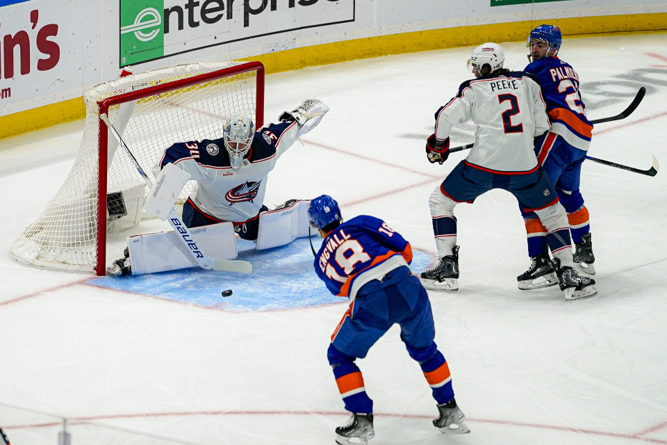 New York Islanders left wing Pierre Engvall (18) shoots against Columbus Blue Jackets goaltender Spencer Martin (30) during the first period of an NHL hockey game in Elmont, N.Y., Thursday, Dec. 7, 2023. (AP Photo/Peter K. Afriyie)