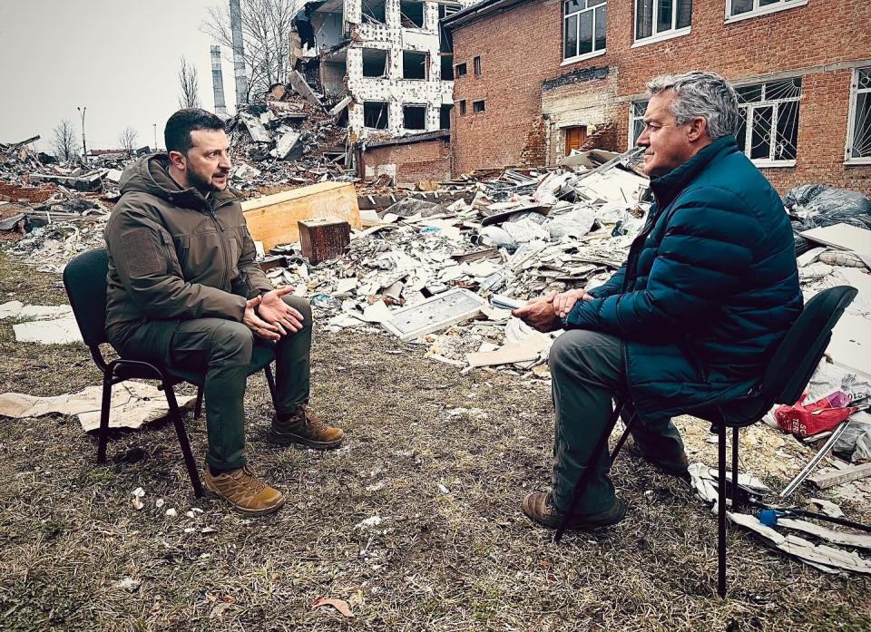 Ukrainian President Volodymyr Zelenskyy, left, speaks with CBS News correspondent Charlie D'Agata near buildings heavily damaged amid Russia's ongoing invasion, in eastern Ukraine, March 27, 2024. / Credit: CBS News/Justine Redman