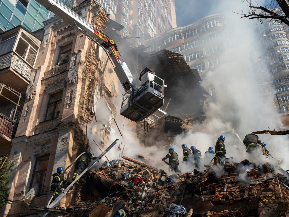 Firefighters work after a drone attack on buildings in Kyiv, Ukraine, Oct. 17, 2022.