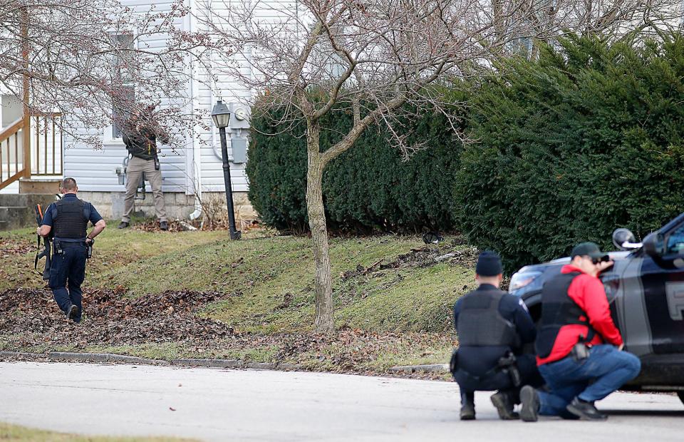 Ashland city and county law enforcement surround a house on Ohio Street on Jan. 5, 2023, in response to a caller who reported a woman had been shot inside the house and another person was in an upstairs bedroom. The information proved false. TOM E. PUSKAR/ASHLAND TIMES-GAZETTE