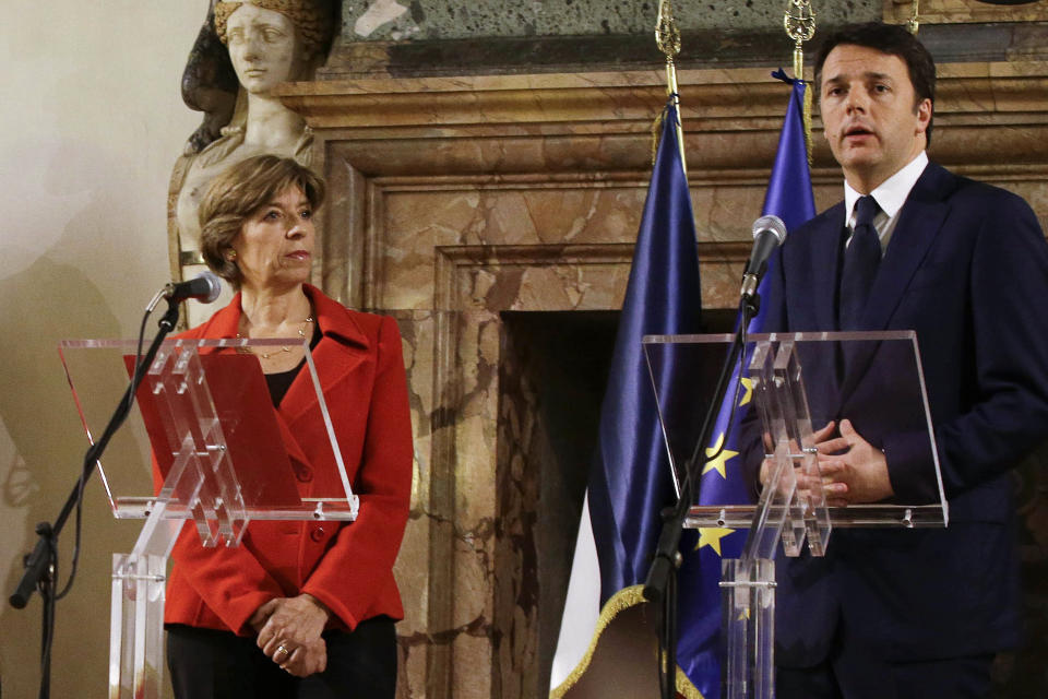 FILE - Italian Premier Matteo Renzi, right, flanked by French Ambassador Catherine Colonna talks to journalists on the occasion of his visit at the French Embassy in Rome, Wednesday, Jan. 7, 2015. Catherine Colonna, a career diplomat and, most recently, France's ambassador to Britain, takes over the foreign affairs portfolio as France is deeply engaged in international efforts to support Ukraine against Russia's invasion and isolate the Kremlin. (AP Photo/Gregorio Borgia, File)