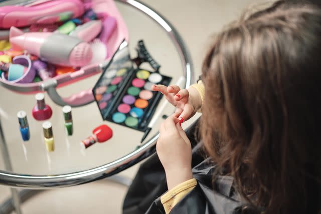 <p>Getty</p> A little girl with a makeup set