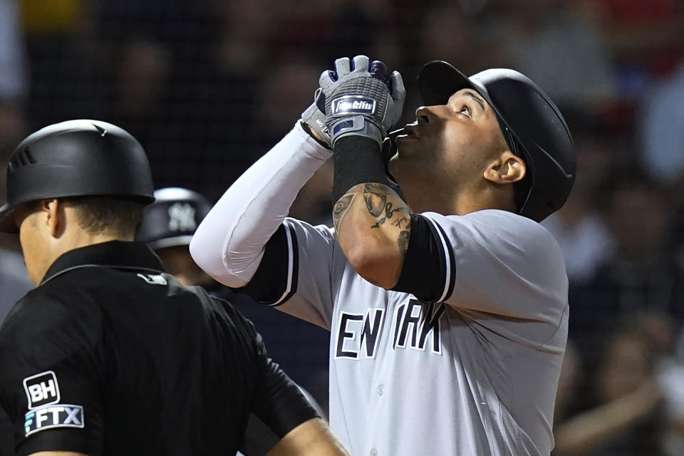 New York Yankees' Marwin Gonzalez celebrates as he arrives at home plate on a two-run home run against the Boston Red Sox during the third inning of a baseball game Tuesday, Sept. 13, 2022, in Boston. (AP Photo/Steven Senne)