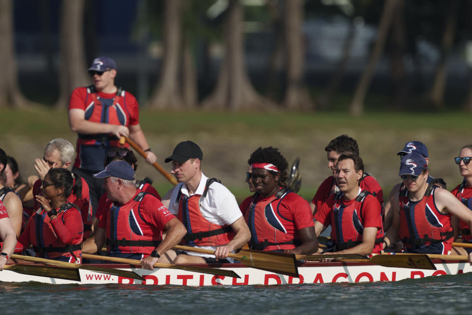 Britain's Prince William, center, participates in a dragon boat event in Singapore, Monday, Nov. 6, 2023. (AP Photo/Vincent Thian)