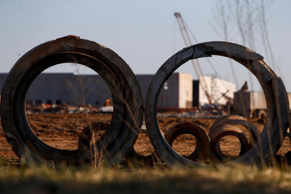 The main building can be seen through concrete pipe resting on the outskirts at the construction site for the future Amazon Distribution Center in Clarksville, Tenn., on Thursday, March 3, 2022. 