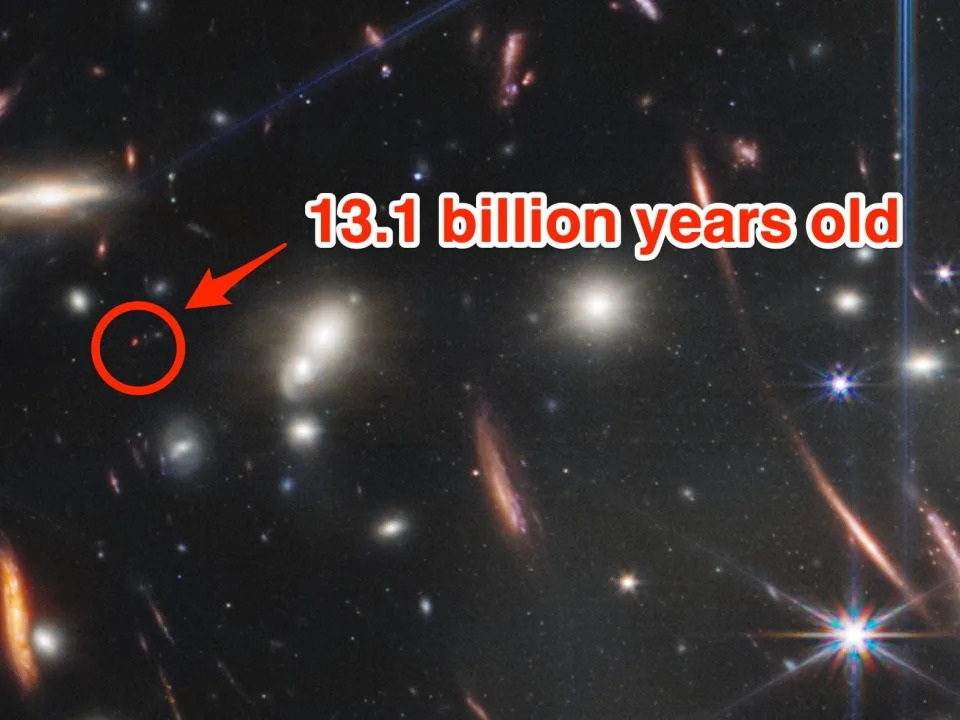 A tiny red dot is annotated as being &quot;13.1 billion years old&quot; on a picture of SMACS 0723 taken by the James Webb space telescope.