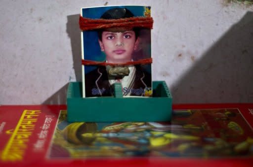 Religious threads adorn a photograph of missing Indian child, Shivam Singh, at his family's residence in New Delhi, pictured on September 12. Thirteen-year-old Shivam Singh promised his mother he would be back to do his homework as he ran to get some sweets. He never returned, becoming one of the 50,000 children who go missing every year in India