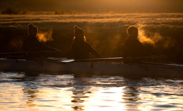 Rowers train on the River Cam in Cambridge at sunrise