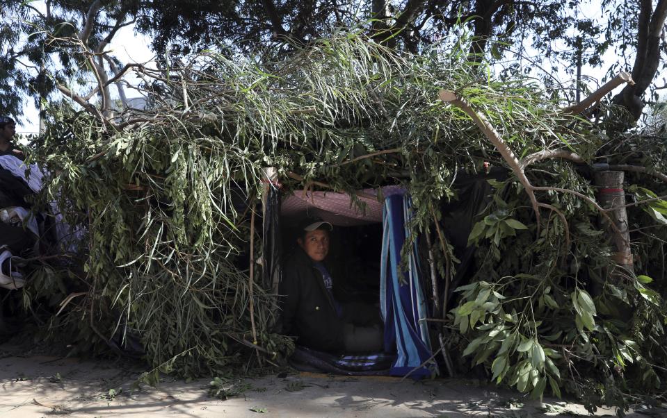 Honduran migrant Mauro Hernandez rests inside a makeshift tent at a temporary shelter in Tijuana, Mexico, early Saturday morning, Nov. 17, 2018. Many of the nearly 3,000 migrants have reached the border with California. The mayor has called the migrants' arrival an "avalanche" that the city is ill-prepared to handle. (AP Photo/Rodrigo Abd)