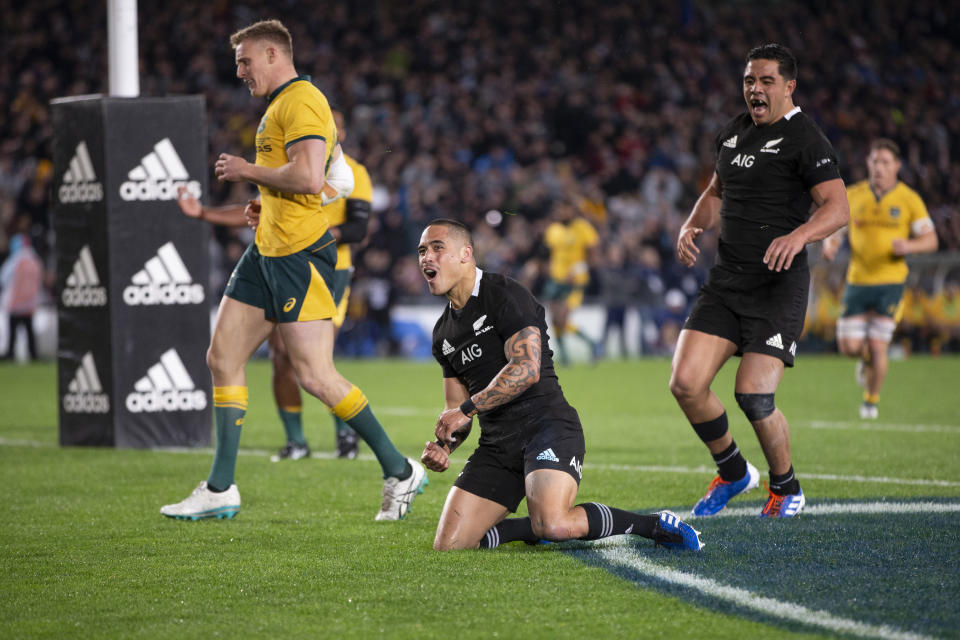 All Blacks halfback Aaron Smith, center, celebrates after scoring against Australia during a Bledisloe Cup rugby test between the All Blacks and Australia at Eden Park in Auckland, New Zealand, Saturday, Aug. 17, 2019. (Brett Phibbs/SNPA via AP)