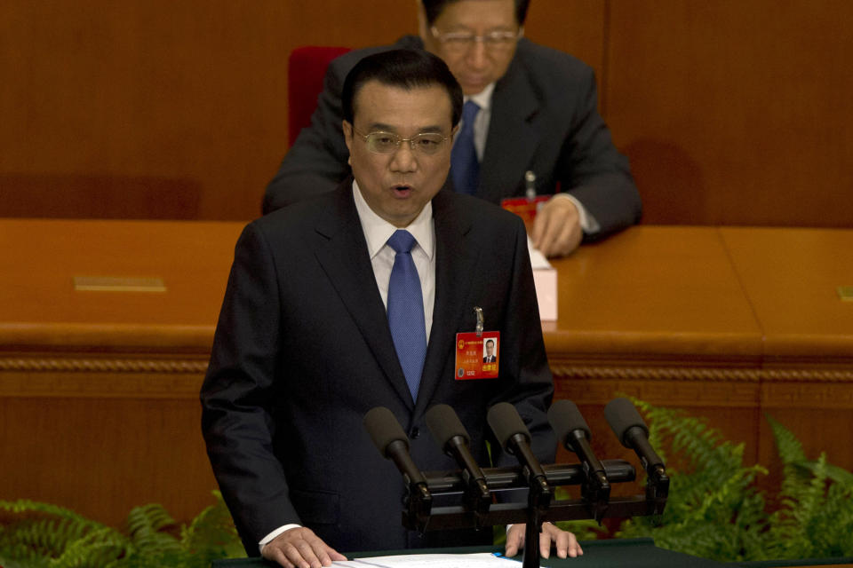 Chinese Premier Li Keqiang delivers a work report during the opening session of the annual National People's Congress in Beijing's Great Hall of the People, China, Wednesday, March 5, 2014. (AP Photo/Ng Han Guan)