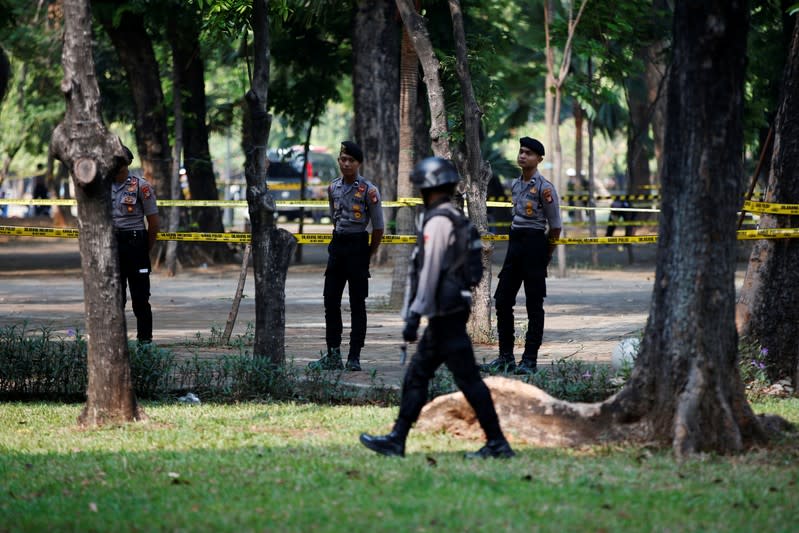 Indonesian police officers stand guard following a blast at National Monument (Monas) complex in Jakarta