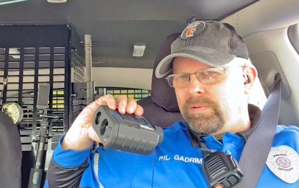 Logan Police Department patrolman Jason Gadrim watches for speeders while interacting with Facebook Live viewers on Sunday. He later pursued a speeding suspect and sang George Strait's "All My Exes Live in Texas" and Dub FX's "Made" while on Rt. 33 between Logan and Columbus.