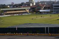 Empty gas canisters are seen placed in a queue by the Galle International Cricket Stadium as ground staff prepare the pitch a day ahead of the first test cricket match between Australia and Sri Lanka in Galle, Sri Lanka, Tuesday, June 28, 2022. (AP Photo/Eranga Jayawardena)