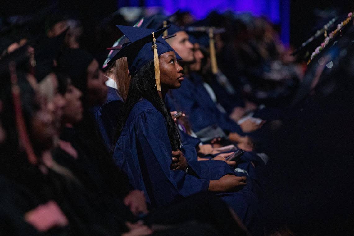 Florida International University graduates watch commencement ceremonies at the Ocean Bank Convocation Center at the Modesto A. Maidique Campus in Miami on Tuesday, Dec. 13, 2022.