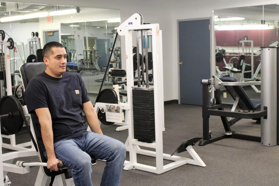 Autstin DeRoche, fitness attendant at the Great Falls Indian Family Health Center, demonstrates a piece of weight lifting equipment in the IFHC's expansive fitness center.
(Photo: David Murray)