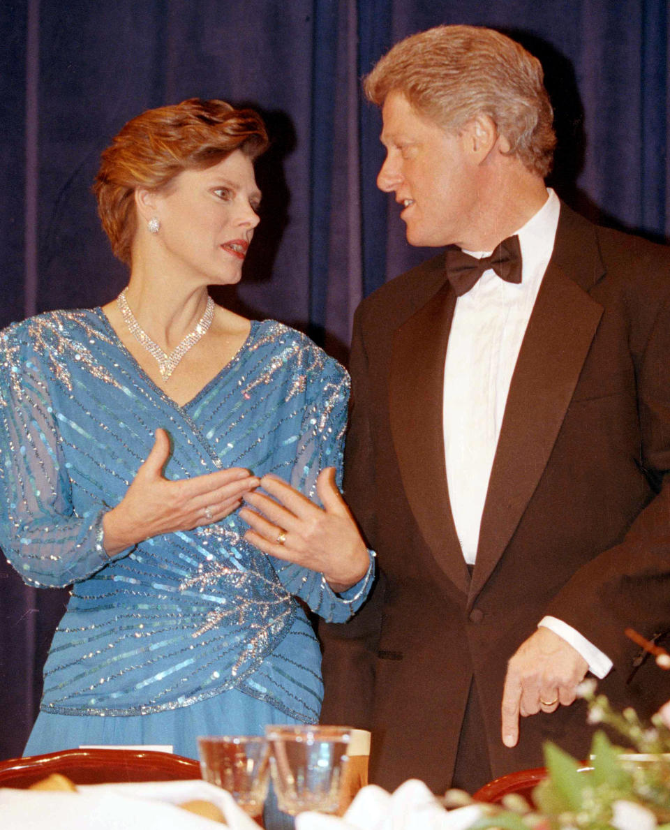 FILE - In this March 18, 1993, file photo, President Bill Clinton, right, speaks with Cokie Roberts, of ABC News, at the Radio and Television Correspondents Dinner in Washington. Roberts, the daughter of politicians who grew up to cover the family business in Washington for ABC News and NPR over several decades, died Tuesday, Sept. 17, 2019, in Washington of complications from breast cancer. She was 75. (AP Photo/Doug Mills, File)