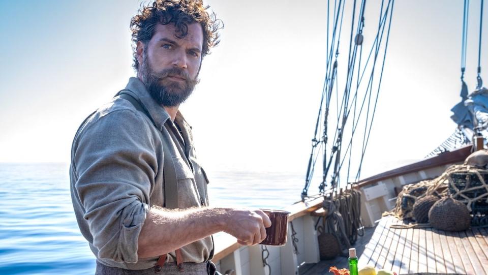 Henry Cavill with a big beard having coffee on a boat in The Ministry of Ungentlemanly Warfare