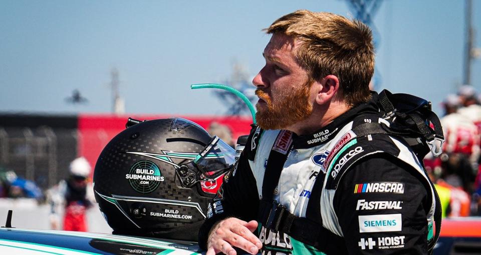 Chris Buescher climbs from his car