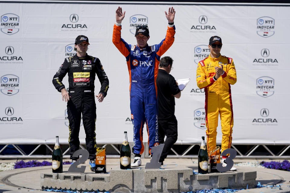 CORRECTS TO ANDRETTI GLOBAL NOT ANDRETTI AUTOSPORT - Chip Ganassi Racing driver Scott Dixon, center, celebrates after his victory in the IndyCar Grand Prix of Long Beach auto race Sunday, April 21, 2024, in Long Beach, Calif. Andretti Global with Curb-Agajanian driver Colton Herta, left, placed second, and Chip Ganassi Racing driver Álex Palou, right, placed third. (AP Photo/Ryan Sun)