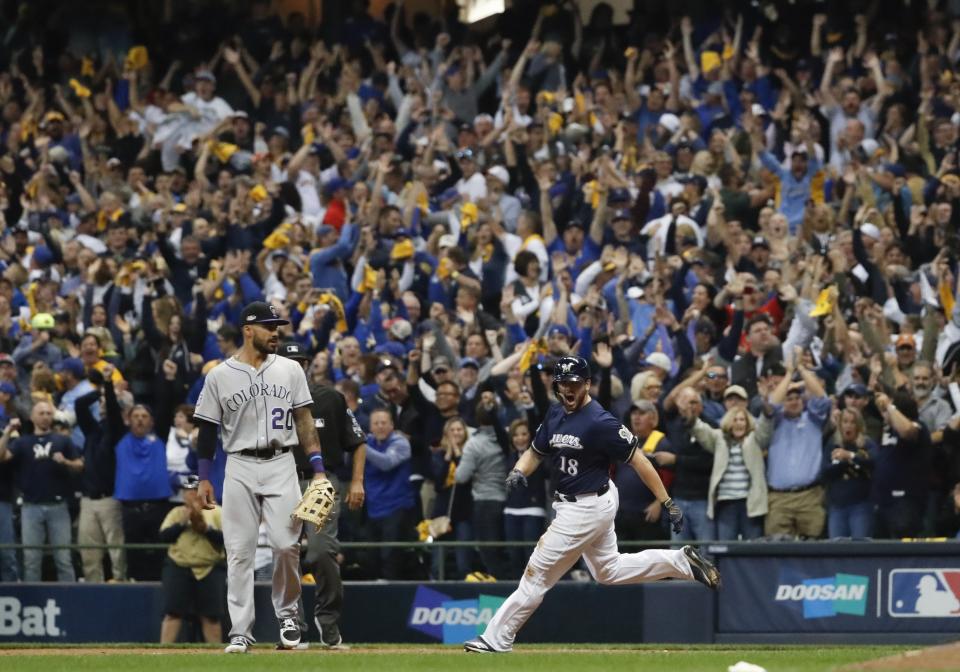 Milwaukee Brewers’ Mike Moustakas hits a walk off RBI single during the 10th inning of Game 1 of the National League Divisional Series baseball game against the Colorado Rockies Thursday, Oct. 4, 2018, in Milwaukee. The Brewers won 3-2 to take a 1-0 lead in the series. (AP Photo/Jeff Roberson)