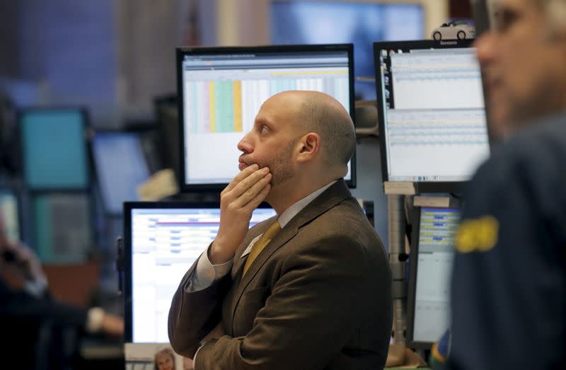 FILE PHOTO: Traders work on the main trading floor of the New York Stock Exchange shortly after the opening bell of the trading session in New York