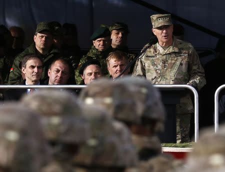 Commander of U.S. Forces in Europe, General Curtis Scaparrotti (R) speaks during U.S.-led NATO troops welcoming ceremony at polygon near Orzysz, Poland, April 13, 2017. REUTERS/Kacper Pempel