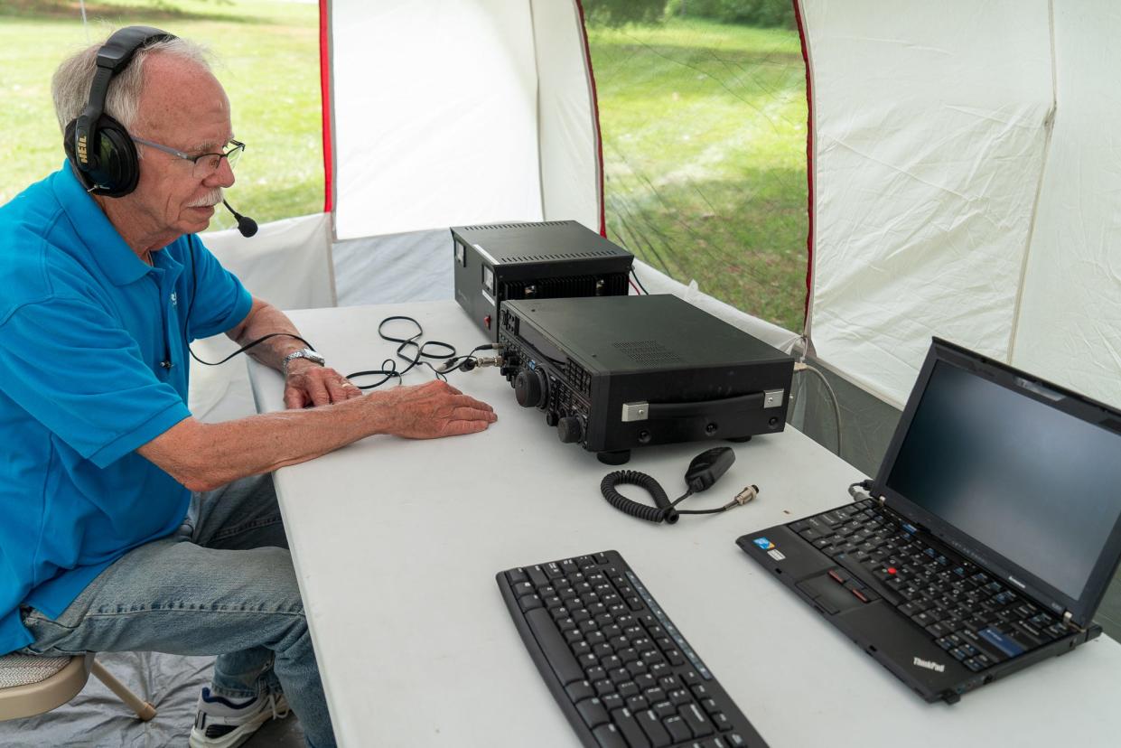 ARRL’s Great Lakes Division Director Dale Williams demonstrates amateur radio equipment inside a camping tent during the annual ham radio Field Day event at Vienna Park on June 25.