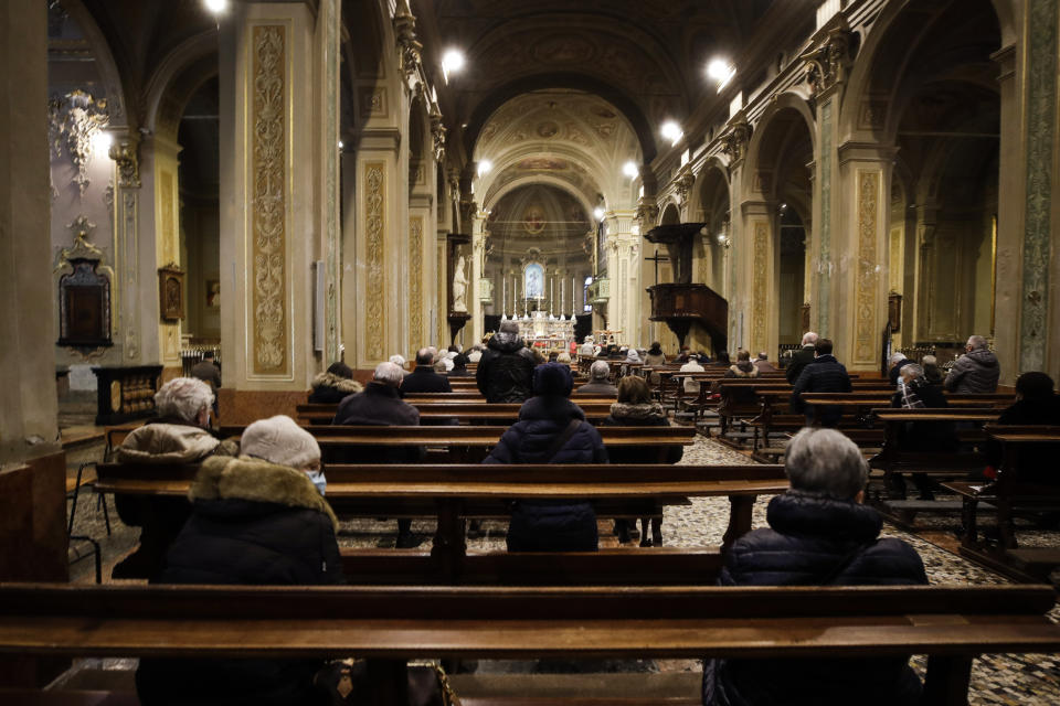 People attend a Mass in Codogno, northern Italy, Sunday, Feb. 21, 2021. The first case of locally spread COVID-19 in Europe was found in the small town of Codogno, Italy one year ago on February 21st, 2020. The next day the area became a red zone, locked down and cutoff from the rest of Italy with soldiers standing at roadblocks keeping anyone from entering of leaving. (AP Photo/Luca Bruno)