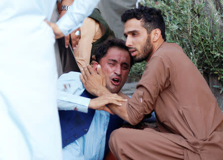 An Afghan man mourns in a hospital after a car bomb, Jalalabad city, Afghanistan June 16, 2018. REUTERS/Parwiz