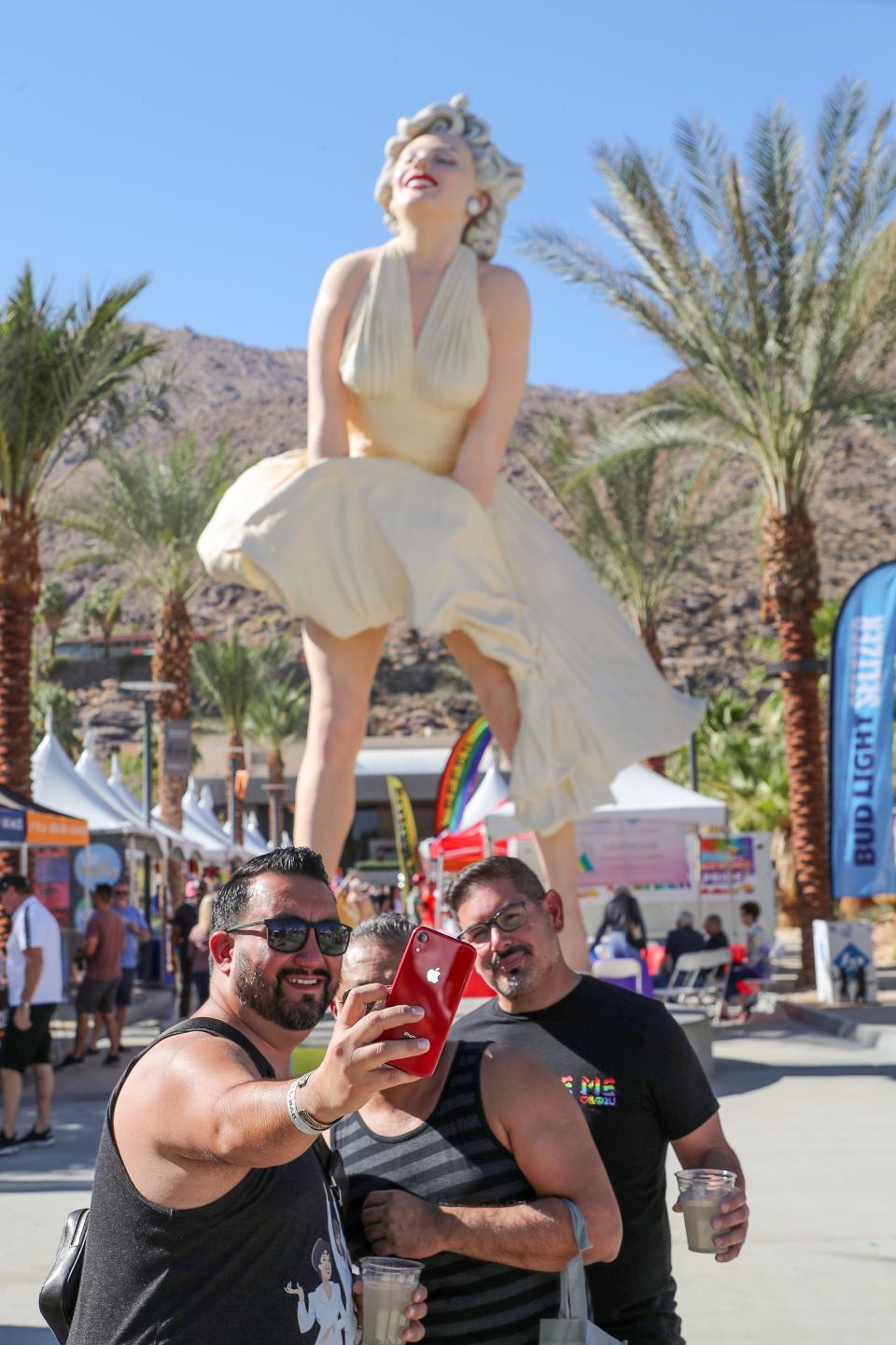 From left, Antonio Vasquez, Rodrigo Castillo and Phillip Quinones take a picture at the Marilyn Monroe Statue as they attend the Pride Festival in downtown Palm Springs, November 6, 2021.  The group was from Phoenix. 