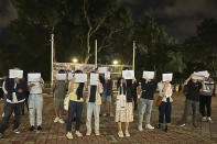 CORRECTS THE PLACE TO CHINESE UNIVERSITY OF HONG KONG - Protesters hold up blank white papers during a commemoration for victims of a recent Urumqi deadly fire, at the Chinese University of Hong Kong in Hong Kong, Monday, Nov. 28, 2022. Students in Hong Kong chanted “oppose dictatorship” in a protest against China’s anti-virus controls after crowds in mainland cities called for President Xi Jinping to resign in the biggest show of opposition to the ruling Communist Party in decades. (AP Photo/Kanis Leung)