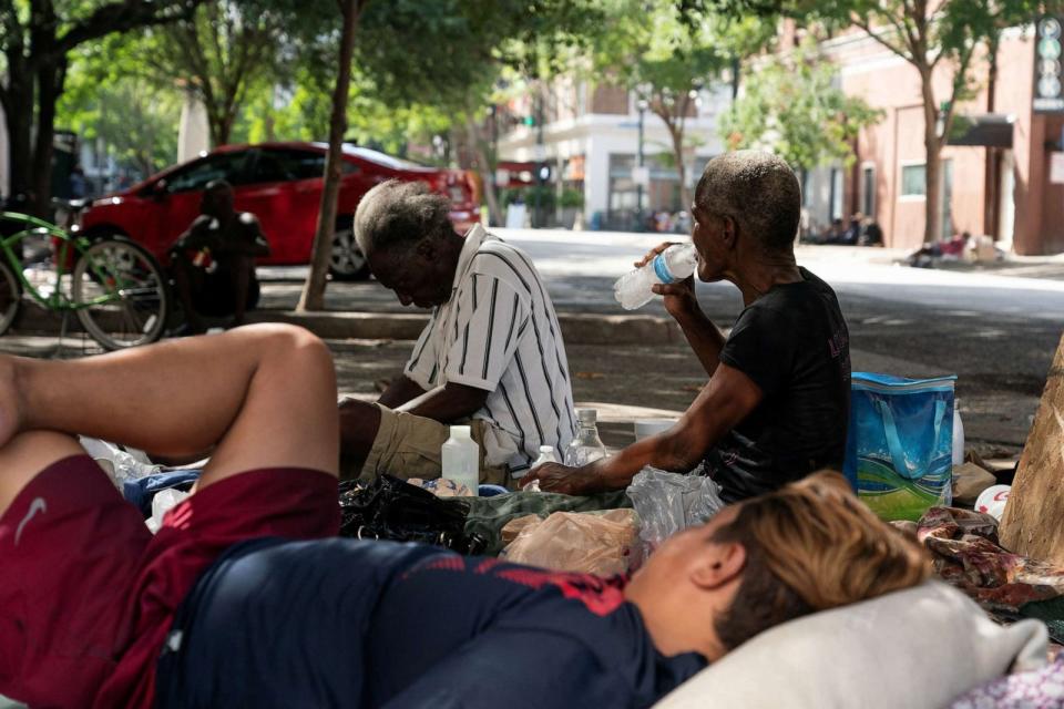 PHOTO: Homeless people rest in the shade in Houston during excessive heat warnings for southeastern Texas on July 16, 2023. (Go Nakamura/Reuters)