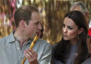 Britain's Prince William holds a ceremonial spear given to him as he talks with his wife Kate, the Duchess of Cambridge. after they arrived at the National Indigenous Training Academy at Yulara, near Uluru, Australia, Tuesday, April 22, 2014. (AP Photo/Rob Griffith)