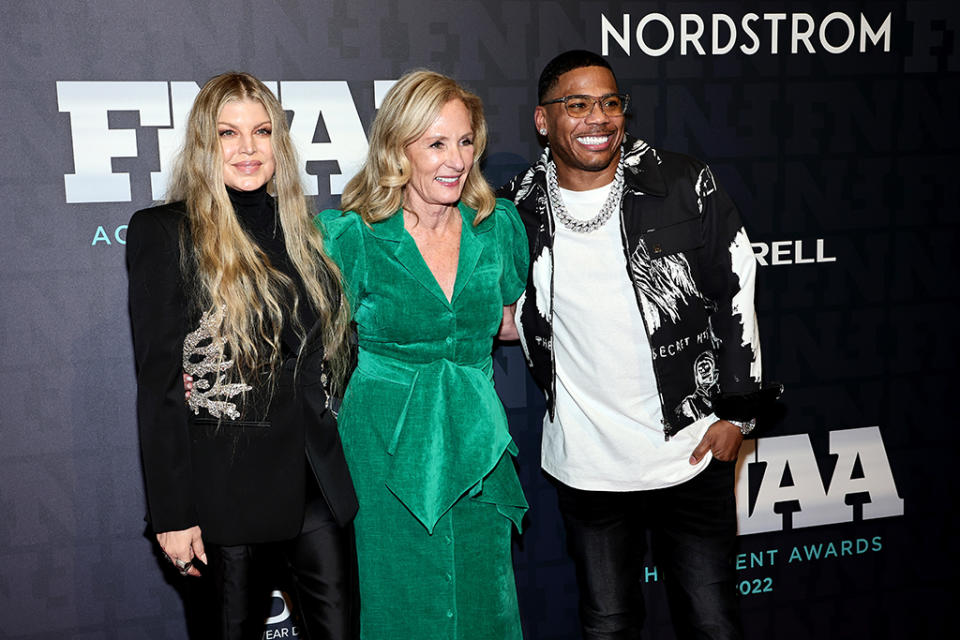 NEW YORK, NEW YORK - NOVEMBER 30: (L-R) Fergie, Diane Sullivan, Nelly attend the 2022 Footwear News Achievement Awards at Cipriani South Street on November 30, 2022 in New York City. (Photo by Jamie McCarthy/Footwear News via Getty Images)