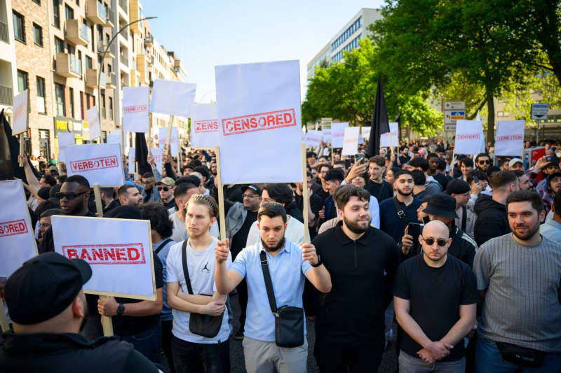 Demonstrators hold up signs with the words "Forbidden" and "Censored" at a rally organized by the Islamist network Muslim Interactive entitled "Against censorship and the dictation of opinion" in Hamburg's St. Georg district. Gregor Fischer/dpa