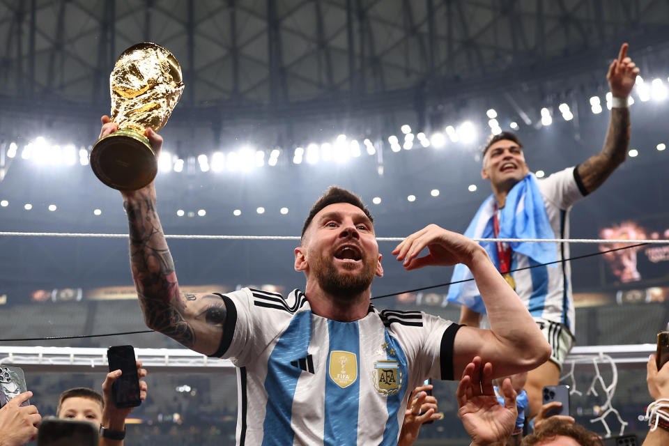 Lionel Messi of Argentina celebrates with the trophy following the FIFA World Cup Final against France.