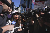 SAG-AFTRA president Fran Drescher, left, speaks with members of the media as she takes part in a rally by striking writers and actors outside Netflix studio in Los Angeles on Friday, July 14, 2023. This marks the first day actors formally joined the picket lines, more than two months after screenwriters began striking in their bid to get better pay and working conditions. (AP Photo/Chris Pizzello)