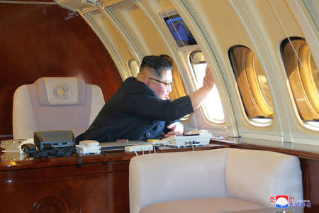 North Korean leader Kim Jong Un looks out an airplane window in this undated photo released on May 9, 2018 by North Korea's Korean Central News Agency (KCNA). KCNA/via REUTERS