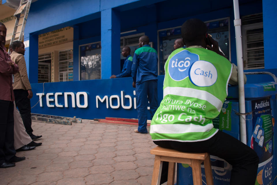 Workers prepare to hoist a Tecno Mobile sign above a new phone store in Kigali, Rwanda. (Photo: Will Boase/Bloomberg via Getty Images)