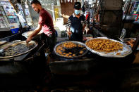 Street venders make traditional sweets at old Basra market, Iraq, Wednesday, Oct. 21, 2020. Iraq is in the throes of an unprecedented liquidity crisis, as the cash-strapped state wrestles to pay public sector salaries and import essential goods while oil prices remain dangerously low.(AP Photo/Nabil al-Jurani)