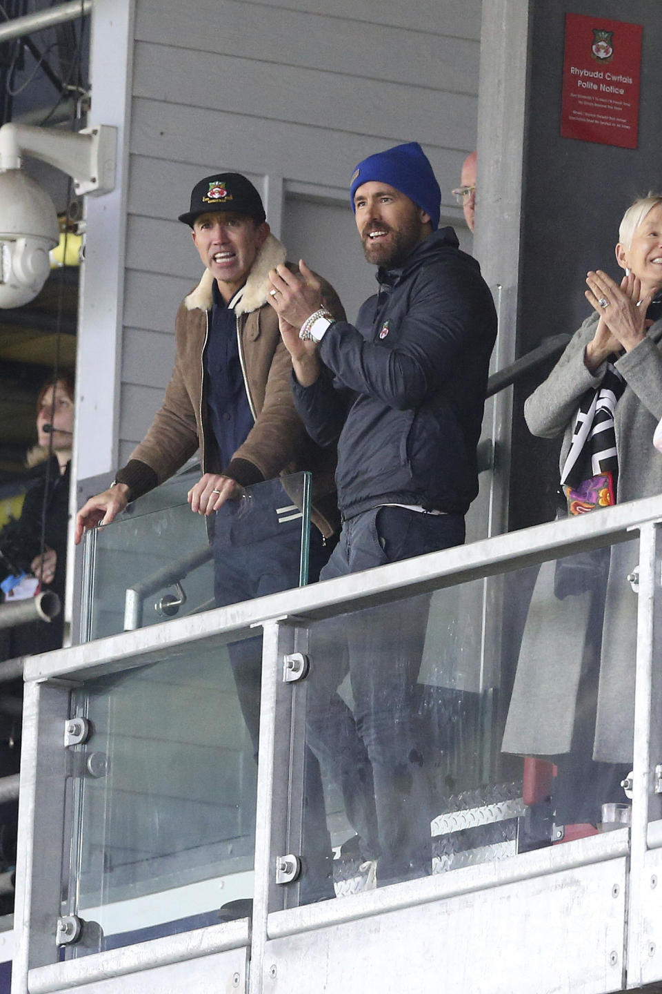 Wrexham owners Ryan Reynolds, right, and Rob McElhenney react during the National League match between Wrexham and Notts County at the Racecourse Ground, Wrexham, Wales, Monday April 10, 2023. (Barrington Coombs/PA via AP)